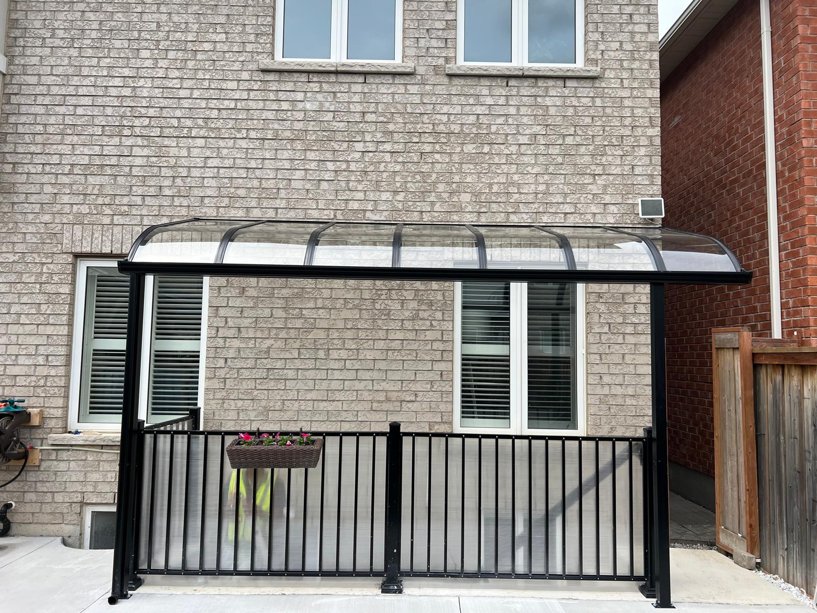 Curved canopy cover over a basement walkout entrance