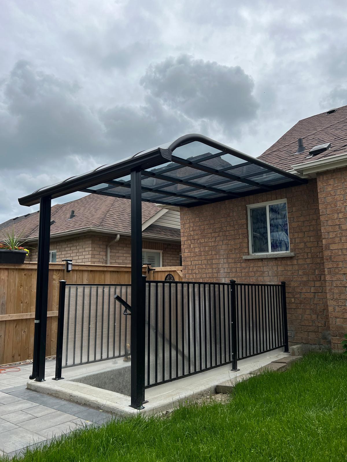 Curved canopy cover over a basement window well